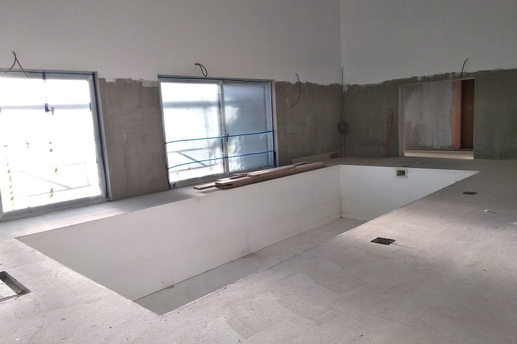 Interior of a house with big swimmig pool under renovation works