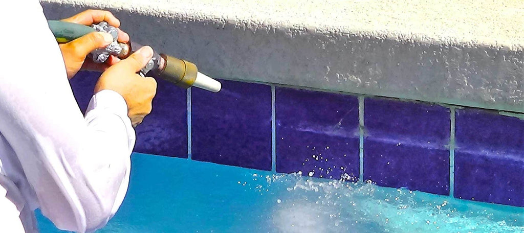 Swim in Style: A Step-by-Step Guide to Cleaning Your Pool - Brushing the tile and grout lines for a sparkling clean look